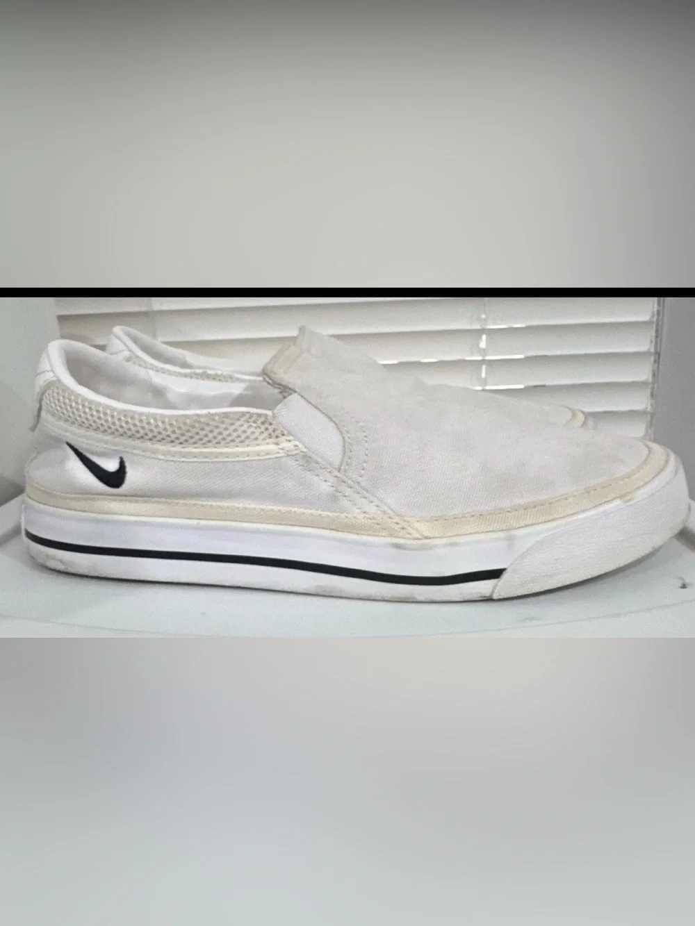 Nike Women’s White Slip-On Sneakers with Black Swoosh Accent